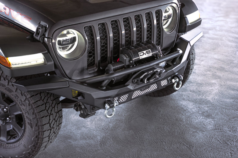 Steel front bumper by DV8 Offroad for Jeep Wrangler JK, JL, and Gladiator JT, featuring rugged off-road design and mounting points.