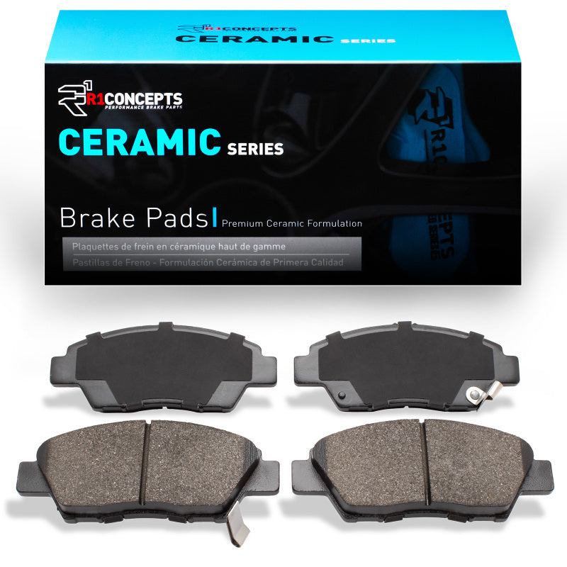 R1 Concepts OE ceramic brake pads for Honda City 09-20, front brake pads installed on a vehicle, showing the brake pad design.