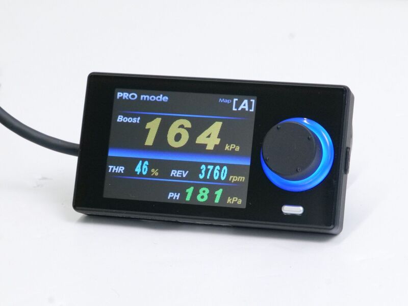 HKS EVC7-MR boost controller installed in a vehicle, showing control unit with display and connection cables.