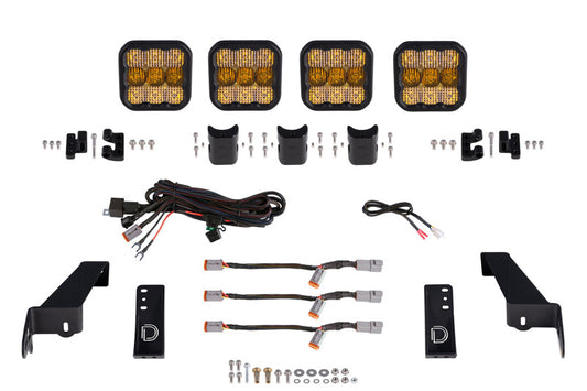 Diode Dynamics Jeep JL SS5 4-Pod CrossLink grille lightbar kit with yellow combo lights, mounted on a Jeep grille for off-road illumination.
