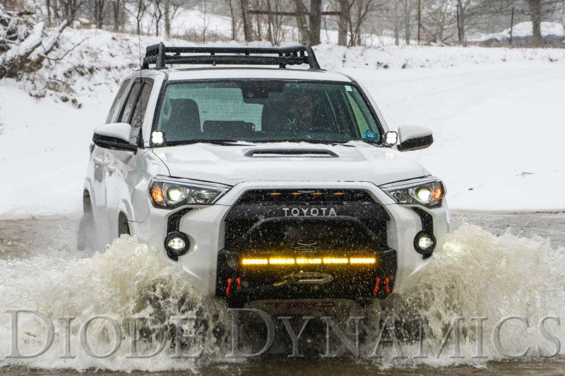 Diode Dynamics Toyota 4Runner Stage Series 2-inch LED ditch light kit with yellow and white sport yellow combo lights installed on vehicle