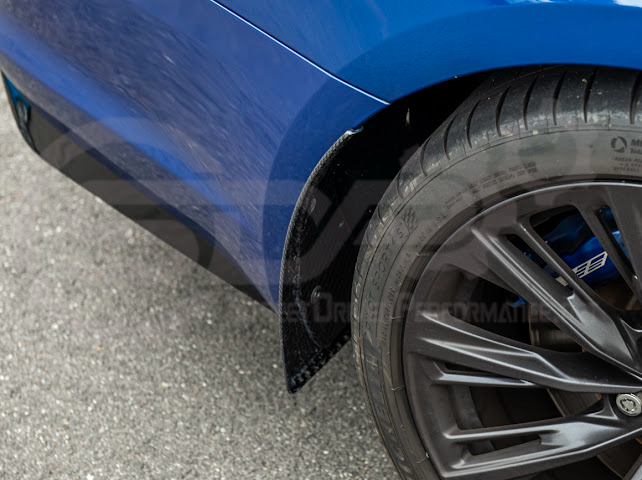 Pair of black carbon fiber mud flaps for 2022-up Cadillac CT5-V Blackwing, designed to protect the vehicle’s sides and wheels.