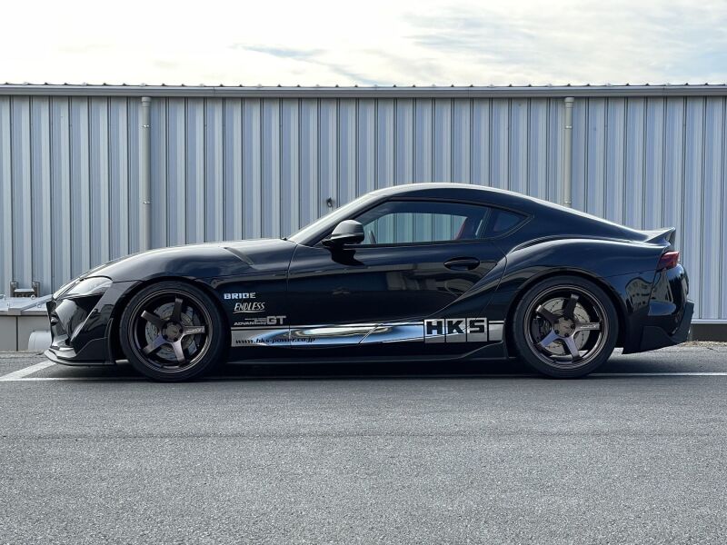 HKS HIPERMAX S coilover kit installed on a vehicle, showcasing adjustable suspension components and performance shocks.