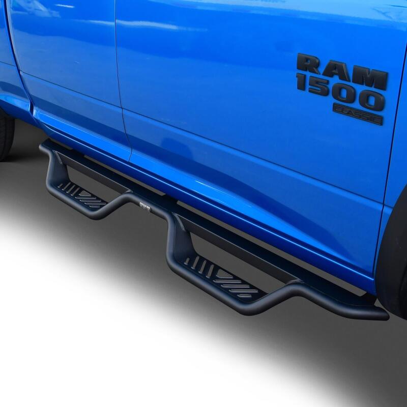 Westin Outlaw Drop Nerf Step Bars in textured black on Ram 1500 quad cab, providing side access and rugged style.