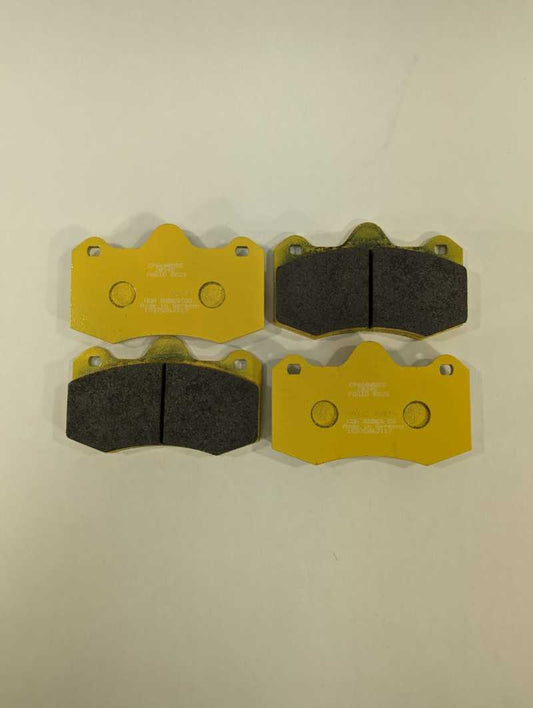 Alcon 2009+ Nissan GT-R R35 rear performance brake pad set, showing close-up of black brake pads with branding and metal backing plates.