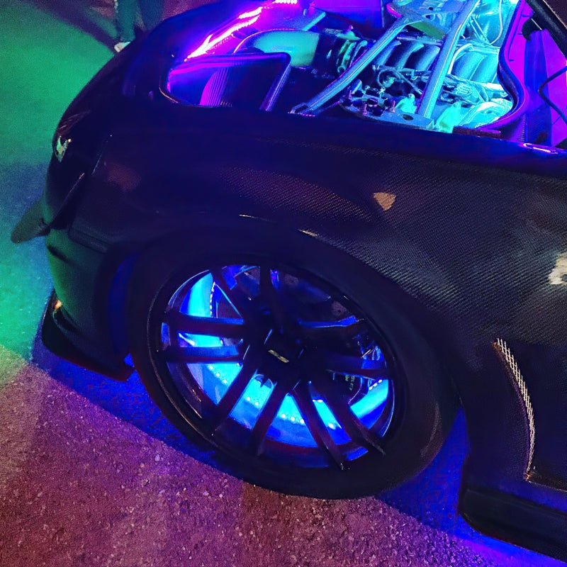 Oracle Lighting LED illuminated wheel rings with ColorSHIFT, showing vibrant multi-color light strip around a car wheel.
