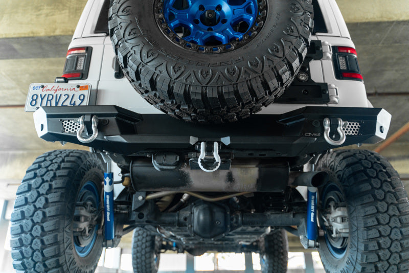 DV8 Offroad steel rear bumper for 2018 Jeep Wrangler JL with optional tire carrier, featuring durable off-road bump protection.