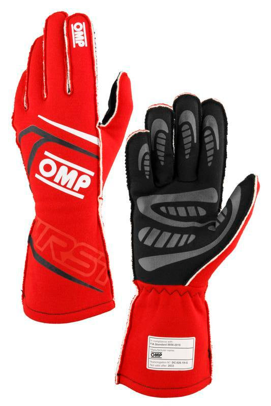 OMP FIRST FIA 8856-2018 racing gloves in black and fuchsia, size M, showing the gloves with detailed stitching and branding.