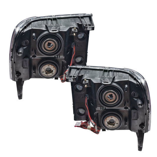 Oracle Lighting blue LED halo headlights for 2007-2013 GMC Sierra, pre-assembled with bright blue halo rings in a close-up view.