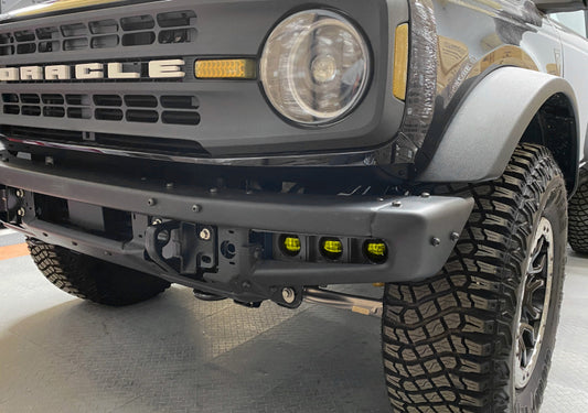 ORACLE Lighting Ford Bronco triple LED fog light kit with yellow lights installed on a steel bumper for 2021-2022 model