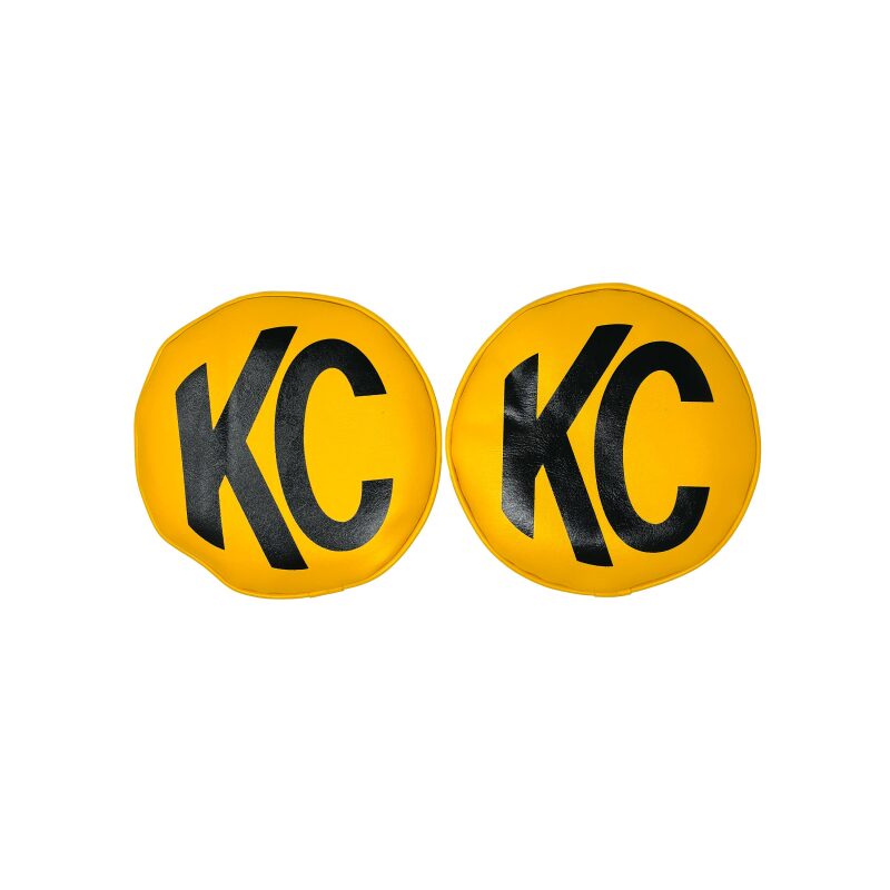 Pair of KC HiLiTES 8-inch round yellow vinyl light covers with black KC logo for off-road vehicle lights.