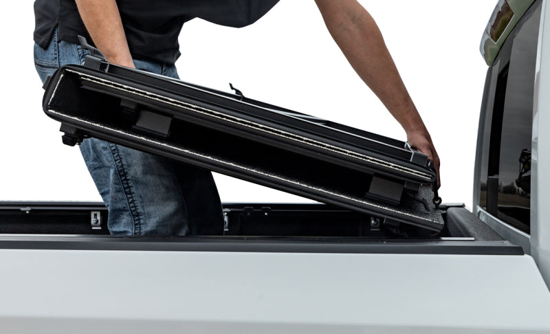 Access LOMAX tri-fold truck bed cover in black diamond mist for 2019 Dodge Ram 1500 with 5ft 7in box, exterior truck bed accessory.