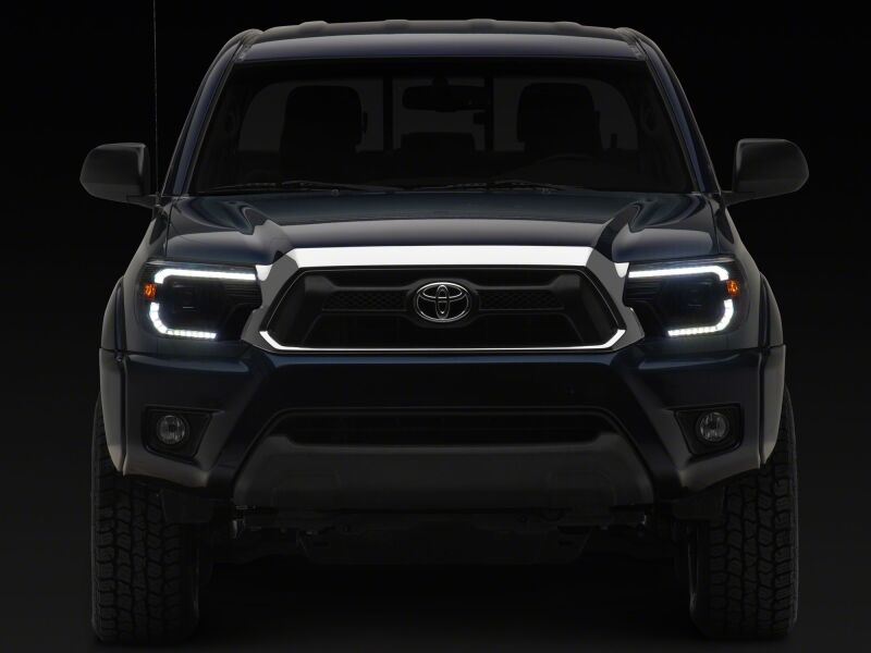 Raxiom Toyota Tacoma axial series projector headlights with black housing and clear lens, designed for 2012-2015 models.