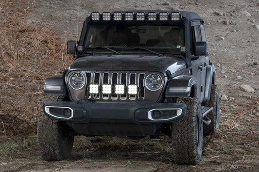Diode Dynamics Jeep JL SS5 4-Pod CrossLink grille lightbar kit with white LEDs installed on the front grille area.