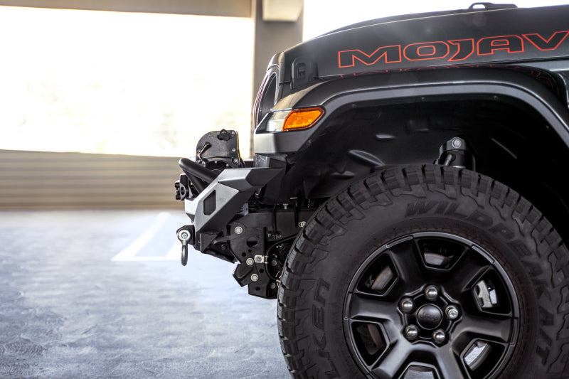 DV8 Offroad steel front bumper for Jeep Wrangler JK, JL, and Gladiator JT, featuring rugged off-road design and mounting points.