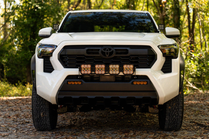 Diode Dynamics 2024 Toyota Tacoma SS5 grille crosslink lightbar kit with sport white and combo lights installed on front grille.