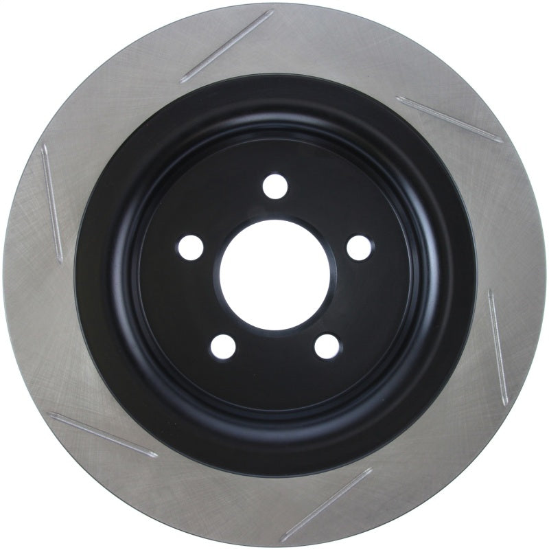 StopTech slotted brake rotor for 2015 Ford Mustang GT with Brembo brakes, left rear view showing slotted surface and mounting holes.