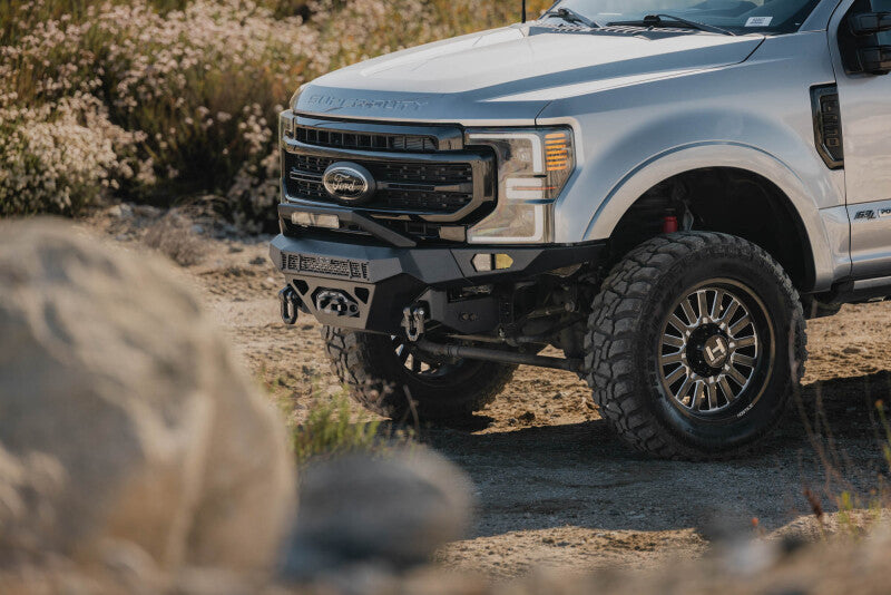 Steel front bumper for Ford Super Duty F-250/F-350, DV8 Offroad Spec Series, durable and rugged front bumper for heavy-duty trucks.