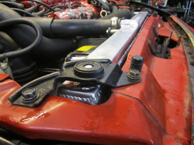 Mishimoto aluminum radiator for 1991-1999 Mitsubishi 3000GT Turbo, showing the sleek silver surface and mounting features.