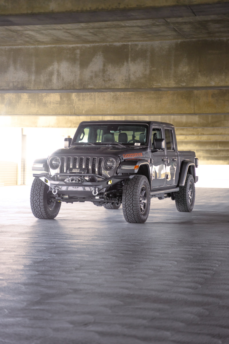 Steel front bumper for Jeep Wrangler JK, JL, and Gladiator JT by DV8 Offroad, featuring rugged off-road design and durable construction.