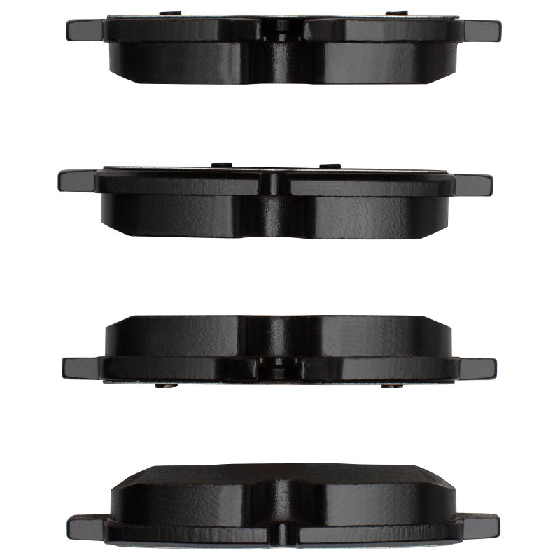 R1 Concepts BMW 650i coupe rear ceramic brake pads, OE type, showing black brake pad with metal backing in a close-up shot.