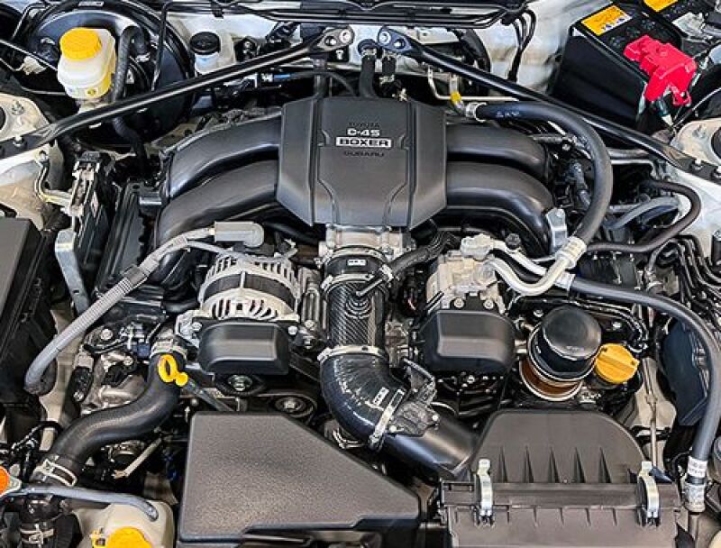 HKS carbon suction kit ZN8/ZD8 with scoops and snorkels installed on a vehicle engine bay