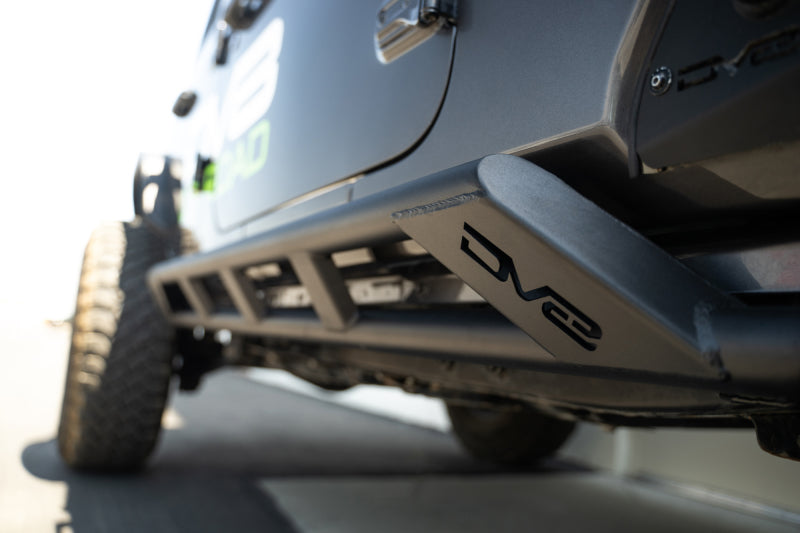 DV8 Offroad 18-23 Jeep Wrangler JL 4-door FS-15 Series rock sliders mounted on vehicle side for protection and off-road durability