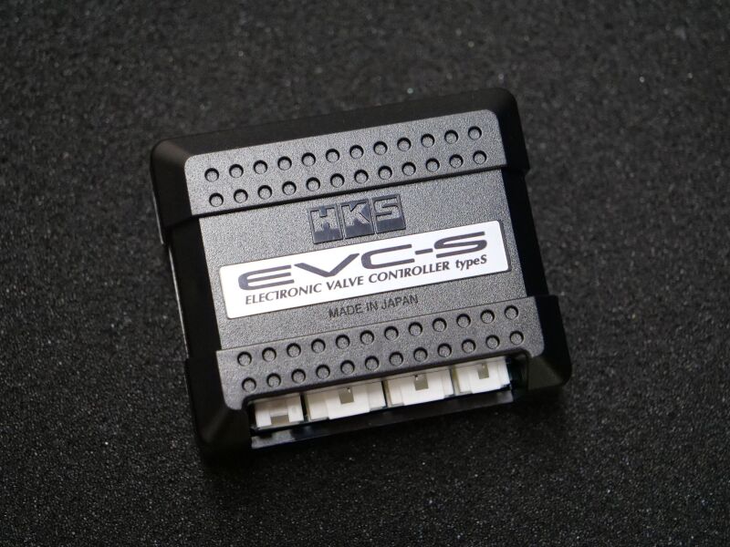 HKS EVC S2 boost controller and BOV blow off valve for forced induction vehicles, with control interface and hoses visible.