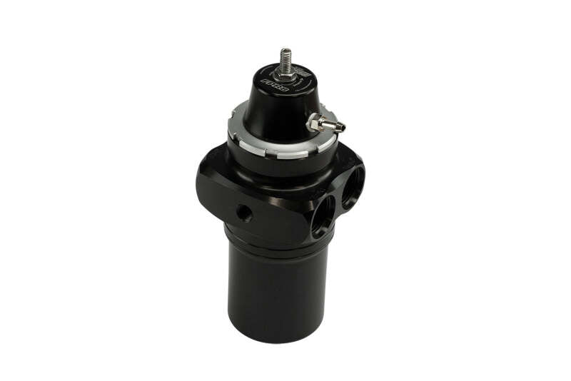 Turbosmart FPRF8 black fuel pressure regulator and filter connected to automotive fuel system components.