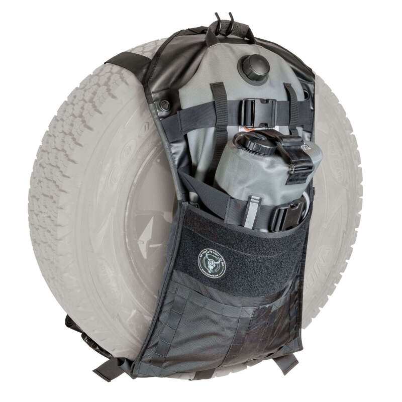 Giant Loop Overland Sling spare tire carrier in black attached to a motorcycle, showcasing durable overland gear for adventure travel.