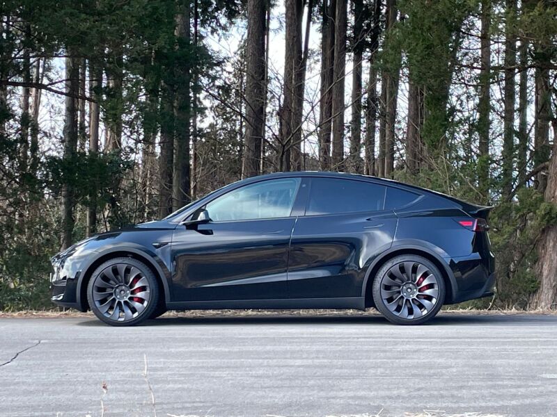 HKS Hipermax S coilover kit installed on a 2022+ Tesla Model Y AWD, showing the adjustable suspension components and sleek design.