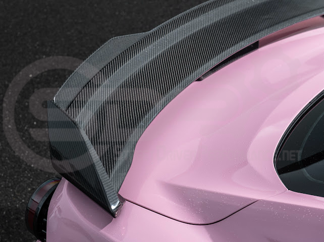 Dark Horse style carbon fiber rear wickerbill spoiler wing on a 2015-2023 Ford Mustang, showing its sleek, aerodynamic design.