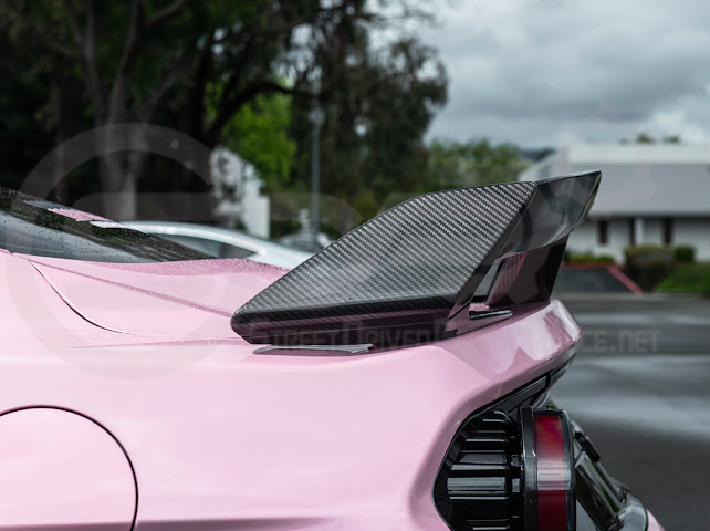 Dark Horse style carbon fiber rear wickerbill spoiler wing on 2015-2023 Ford Mustang, featuring sleek aerodynamic design.