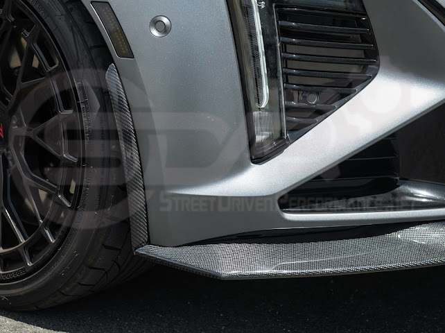 Cadillac CT5-V Blackwing factory OEM style carbon fiber front lip splitter and wheel arch extensions, designed for ground effects.