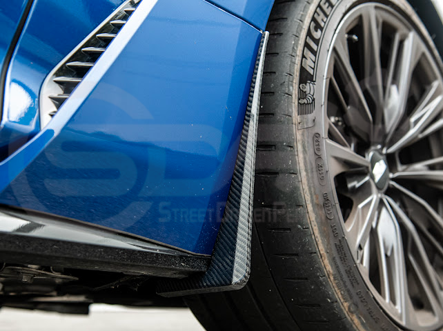 Pair of black carbon fiber mud flaps for 2022-up Cadillac CT5-V Blackwing, designed to protect the vehicle's front and rear splash areas.