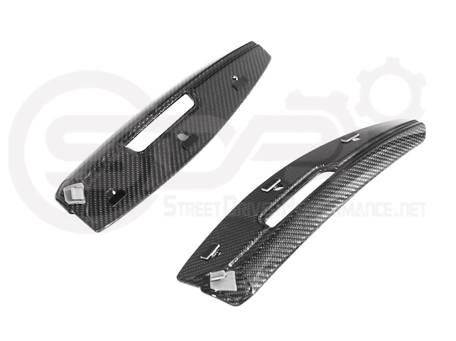Cadillac CT5-V Blackwing factory OEM style carbon fiber front lip splitter and wheel arch accents on a sleek car.
