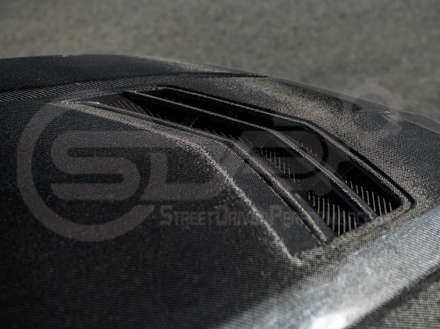Black carbon fiber vented front hood for 2020+ Cadillac CT4, CT4-V, Black Wing, and Sport models by Street Driven Performance.
