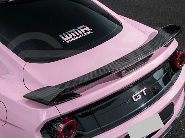 Dark Horse style carbon fiber rear wickerbill spoiler wing on a 2015-2023 Ford Mustang, showcasing sleek automotive design.