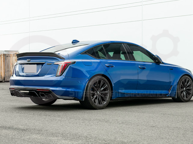 Pair of carbon fiber mud flaps for 2022-up Cadillac CT5-V Blackwing, designed to protect the vehicle from road debris.