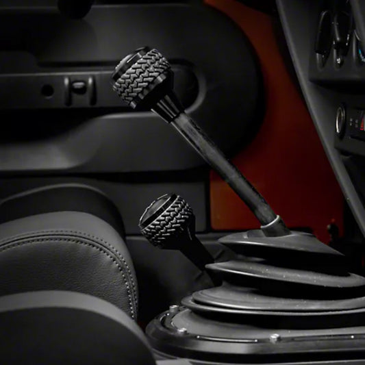 Black DV8 Offroad 2011-2018 Jeep JK 6-speed shift knob, close-up view showing textured surface and ergonomic design.