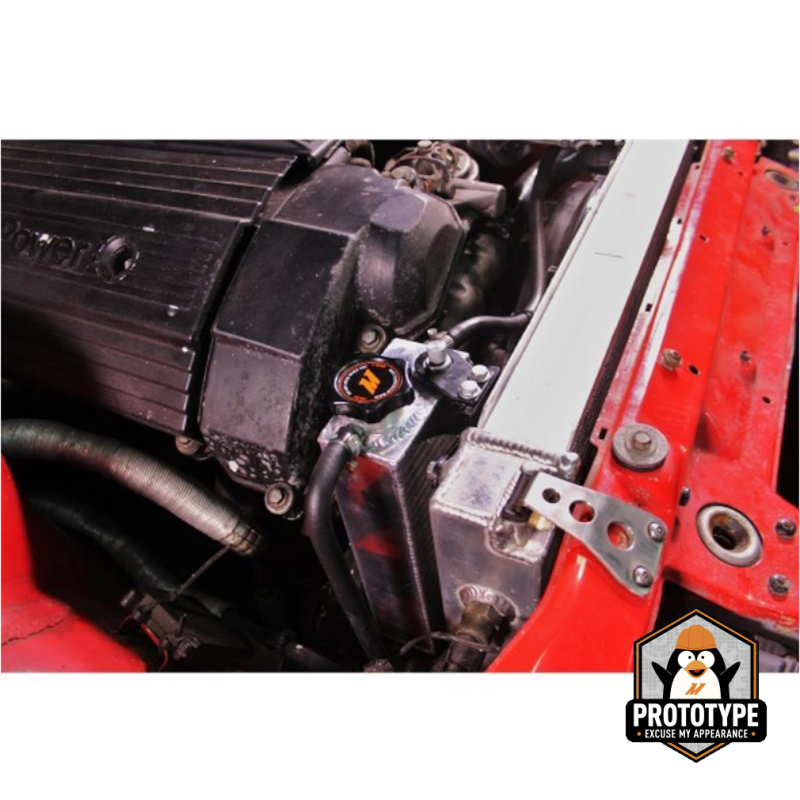 Mishimoto aluminum coolant expansion tank for BMW 3 Series 92-99, aftermarket coolant reservoir with mounting hardware.