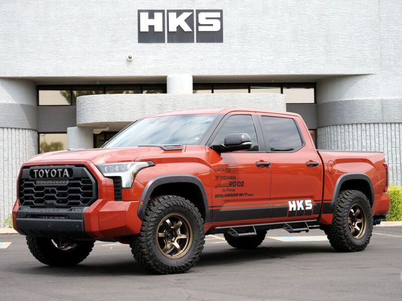 HKS Legamax Trail Master 2022 Tundra catback exhaust system installed on a truck, showcasing the sleek exhaust pipes and muffler.