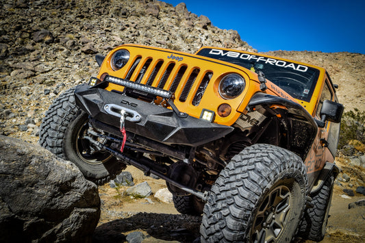 Black aluminum inner fender liner for Jeep Wrangler JK front wheel well by DV8 Offroad, designed for off-road durability.