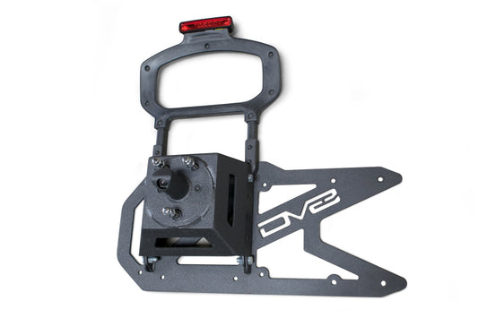 DV8 Offroad Jeep Wrangler JL tailgate mounted tire carrier on chase rack, showcasing rugged off-road vehicle accessory.