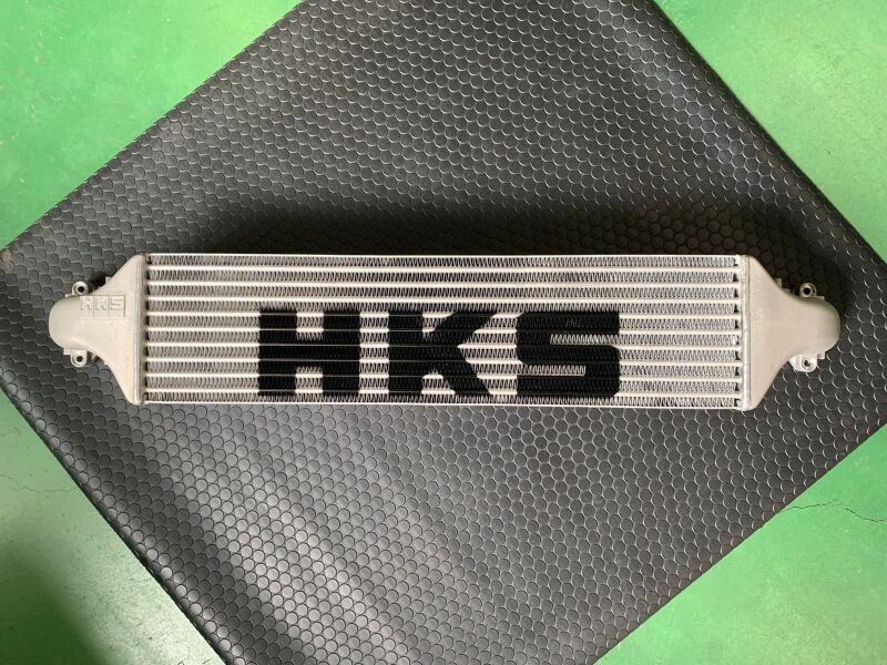 HKS Civic Type R FL5 intercooler kit showing the large aluminum intercooler core with HKS branding and mounting hardware.