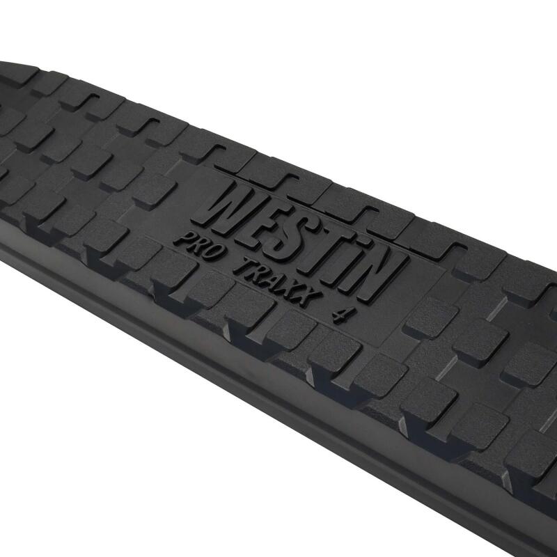 Westin PRO TRAXX 4 Oval Nerf Step Bars in black installed on a Toyota Tacoma Double Cab, providing side step access.