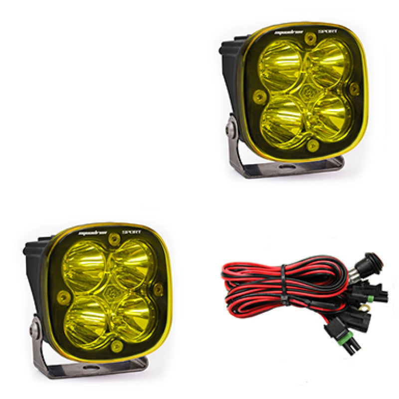Baja Designs Squadron Sport LED light pods in amber, mounted on a vehicle for work or scene lighting, showcasing compact, durable design.