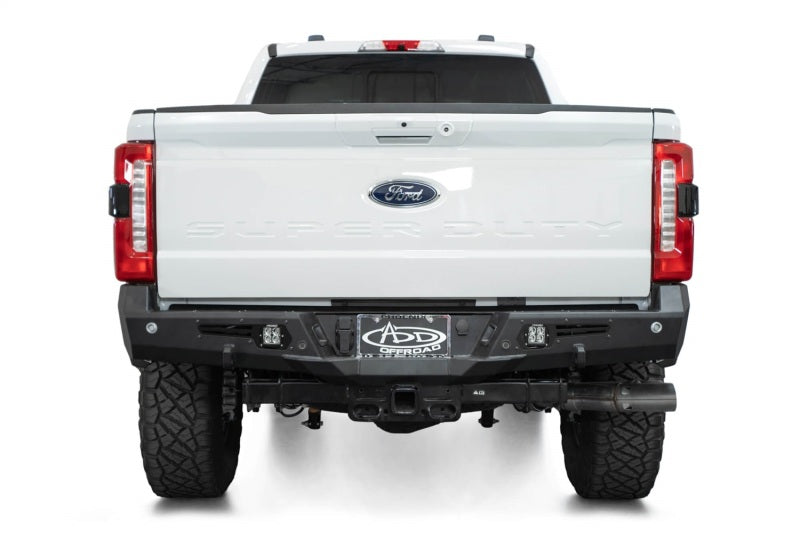 Addictive Desert Designs steel bomber rear bumper installed on a 2023-2024 Ford F-150 Super Duty pickup truck.