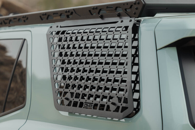 DV8 Offroad Toyota 4Runner exterior window Molle panel for DV8 roof rack on driver side, part of the vehicle's exterior trim.