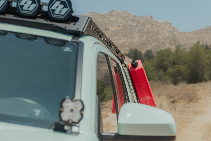 DV8 Offroad Toyota 4Runner exterior window Molle panel for DV8 roof rack on driver side, part of the vehicle's exterior trim.